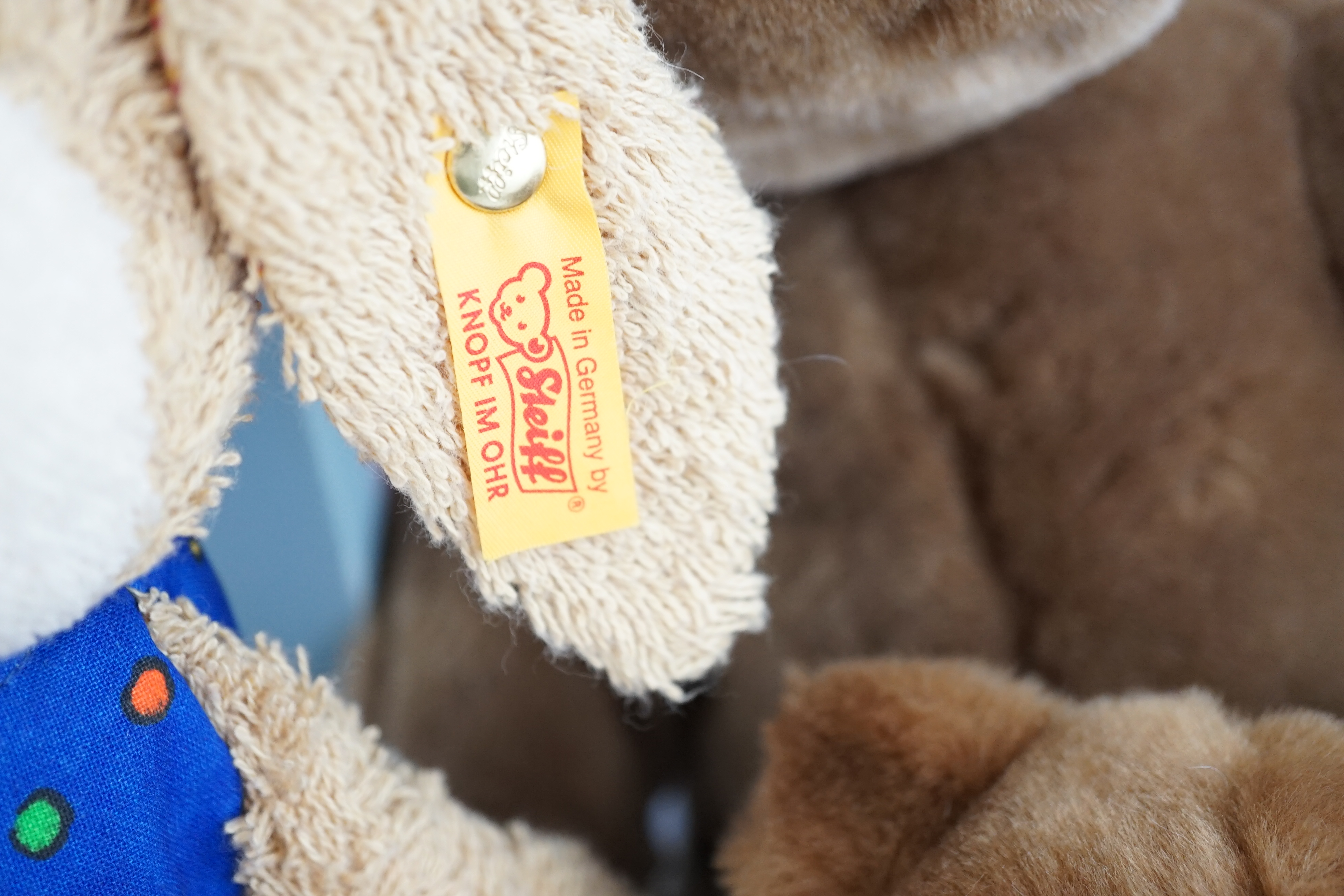 Four Steiff toys including Boxer dog and Rupert Bear
